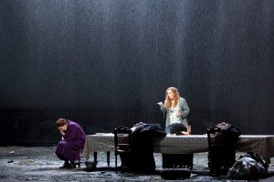 Kataja Kabanova: Eva-Maria Westbroek, Sopran, vor leerem Tisch. Deborah Polaski denkt nach // Foto: Uhlig / staatsoper-berlin.de